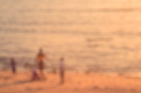 Blur children playing on tropical sunset beach abstract background.Travel concept.Retro color style.の写真素材