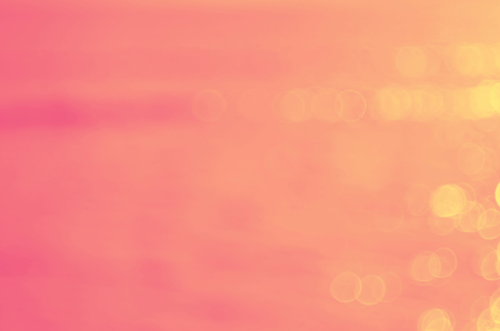 Blur tropical sunset beach with bokeh sun light wave abstract background. Travel concept. Retro color style.の写真素材