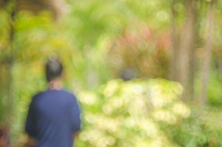 Blur woman walking in nature green park abstract background.の写真素材