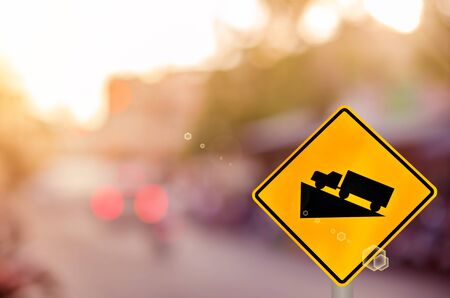 Traffic sign, up hill on blur road background. Retro color style.の写真素材