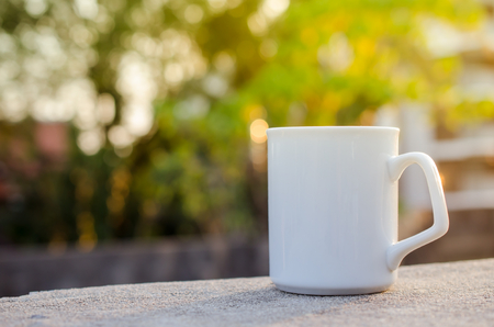 Close up a cup of coffee with bokeh sun light background, shallow depth of field.の写真素材