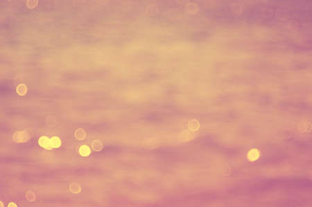 Blur tropical sunset beach with bokeh sun light wave abstract background. Travel concept. Retro...