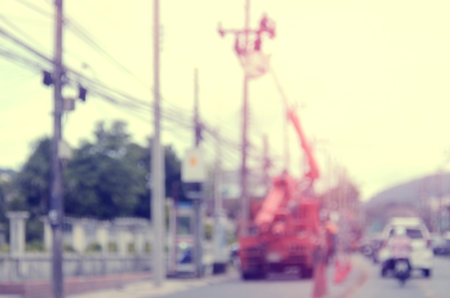 Blur worker repair electricity post on traffic road abstract background.Retro color style.の写真素材