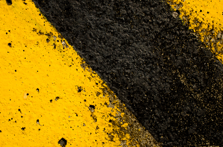 Traffic sign black and yellow color texture background.の写真素材