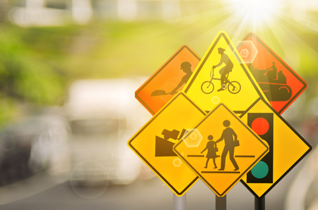 Set of traffic warning sign on blur traffic road with colorful bokeh light abstract background. Copy space of transportation and travel concept. Retro tone filter color style.の写真素材