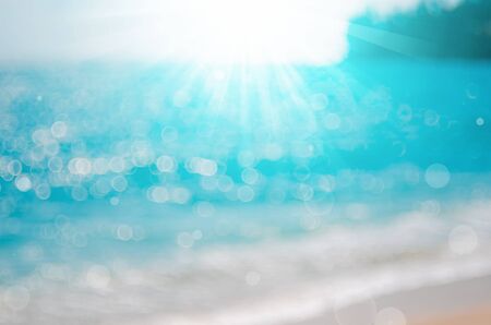 Blur tropical beach with bokeh sun light wave abstract background. Copy space of outdoor summer vacation and travel adventure concept. Vintage tone filter color style.の写真素材