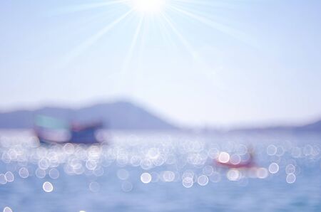 Blur fisherman boats on tropical beach with bokeh sun light wave abstract background. Copy space of summer vacation and business travel concept. Vintage tone color filter style.の写真素材