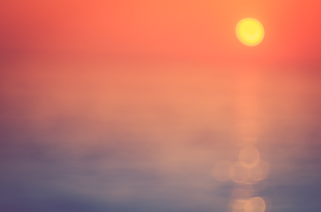 Blur tropical sunset beach with bokeh sun light wave abstract background. Travel concept. Retro...