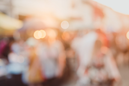 Blur people shopping in local market walking street in sunset abstract background. Copy space of travel and business concept. Vintage tone filter color style.の写真素材