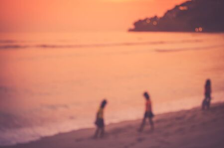 Blur kids playing on tropical sunset beach. Travel concept. Retro color style.の写真素材