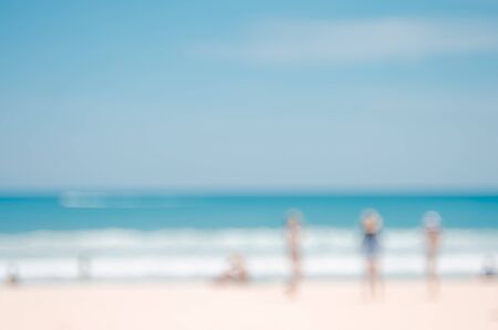 Blur people relax on white sand beach with blue sky abstract background. Retro color style.の写真素材