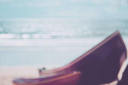 Blur boat on tropical beach and blue sky white cloud with bokeh sun light wave abstract background. Copy space of summer vacation and business travel concept. Vintage tone filter color style.の写真素材