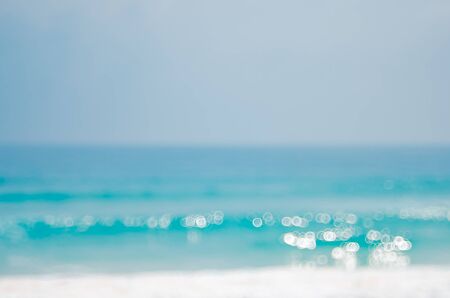 Blur tropical beach with bokeh sun light wave abstract background. Copy space of summer vacation and business travel concept. Vintage tone color filter style.の写真素材