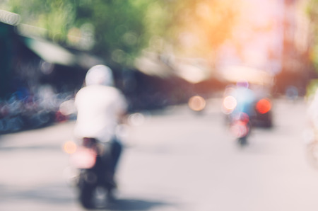 Blur traffic road with colorful bokeh light abstract background. Copy space of transportation and travel concept. Retro tone filter color style.の写真素材