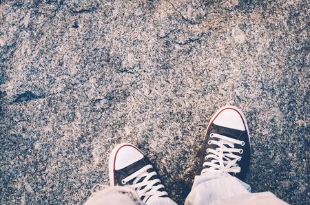 Top view of shoes and blue jean on street, selfie, travel concept.Retro color style.の写真素材