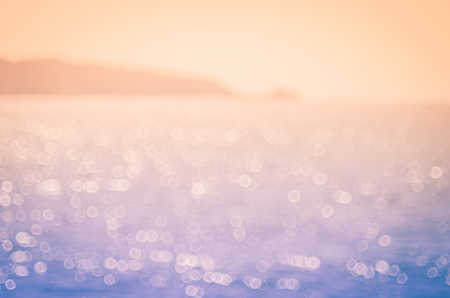 Blur tropical beach with bokeh sun light wave abstract background. Travel concept. Retro color style.の写真素材