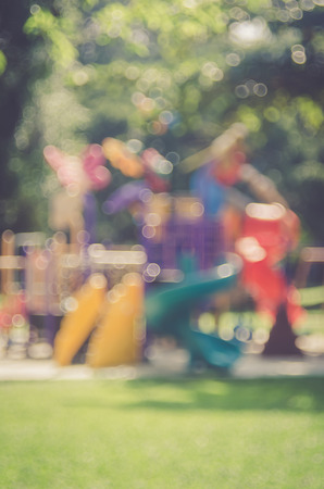 Blur colorful playground in nature green park abstract background. Copy space of sport exercise and health care concept. Vintage tone filter color style.の写真素材