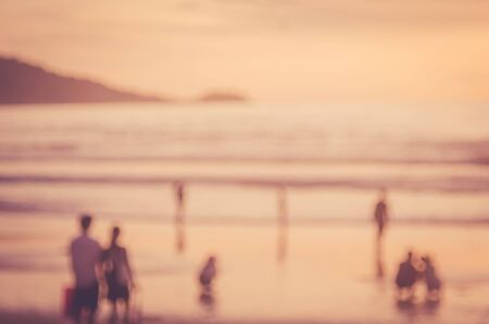 Blur people relax on tropical sunset beach abstract background. Travel concept. Retro color style.