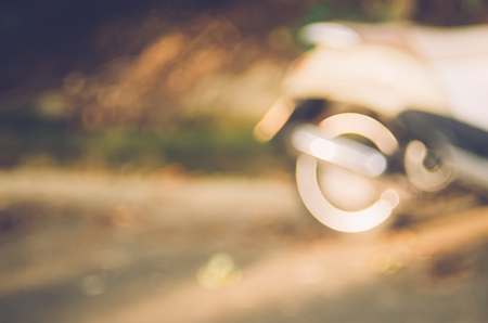 Blur motorbike on road abstract background. Copy space of travel adventure and transport concept. Vintage tone filter color style.の写真素材