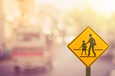 Traffic sign,school sign on blur traffic road abstract background.Retro color style.の写真素材