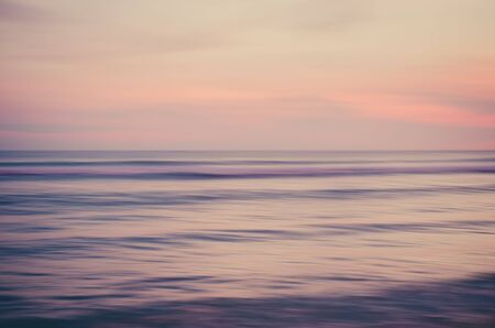 Motion blur tropical sunset beach with bokeh sun light wave abstract background. Copy space of...
