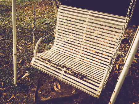 Old swing in playground. Retro tone filter color style.の写真素材