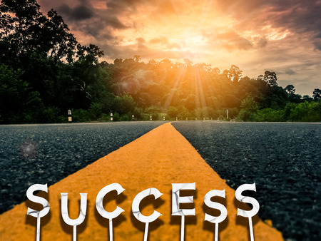 success words on yellow line on country road in storm cloud and mountain background. Travel adventure and transportation concept. Retro tone filter effect color style.の写真素材