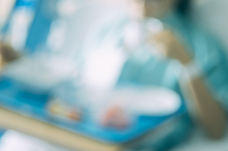 Blur patient woman eating food on bed in hospital abstract background. Copy space of health care and food drink concept. Vintage tone filter effect color style.の写真素材