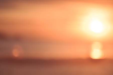 Blur tropical sunset beach with bokeh light wave abstract background. Copy space of outdoor summer vacation and business travel adventure concept. Vintage tone filter effect color style.の写真素材