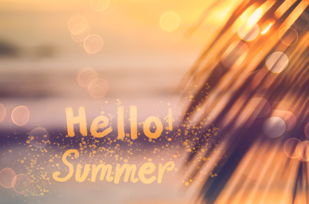 Hello ! Summer words on blur nature palm leaf tropical sunset beach and bokeh light wave abstract background. Copy space of summer vacation and business travel concept. Vintage tone filter color styleの写真素材