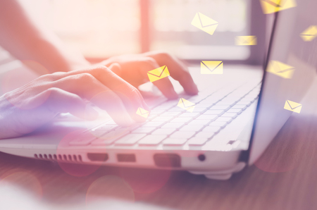 Business economic technology and working connect concept. Close up woman hand using notebook double exposure email fly draw graphic colorful bokeh background. Vintage tone filter effect color style.の写真素材