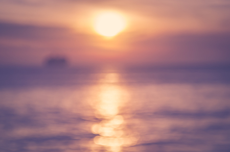 Blur tropical sunset beach with bokeh light wave abstract background. Copy space of outdoor summer vacation and business travel adventure concept. Vintage tone filter effect color style.の写真素材