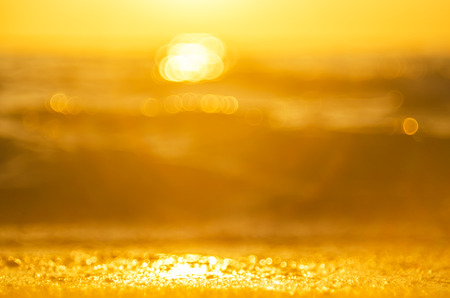 Blur tropical sunset beach with bokeh light wave abstract background. Copy space of outdoor summer vacation and business travel adventure concept. Vintage tone filter effect color style.の写真素材