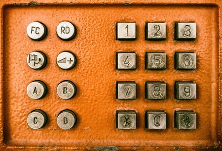 Close up old button number payphone. Retro tone filter effect color style.の写真素材