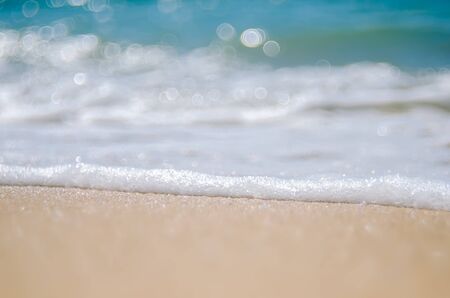 Blur tropical beach with bokeh sun light wave abstract background. Copy space of outdoor summer vacation and travel adventure concept. Vintage tone filter effect color style.の写真素材