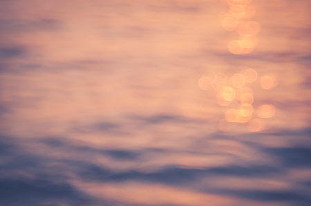 Blur tropical sunset beach with bokeh light wave abstract texture background. Copy space of outdoor summer vacation and business travel adventure concept. Vintage tone filter effect color style.の写真素材