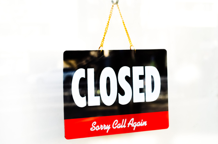 Old Close sign hanging front of cafe mirror door. Business service and food drink concept.
