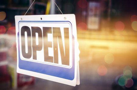 Open sign broad through the glass of door in cafe. Business service and food concept. Vintage tone filter color style.の写真素材