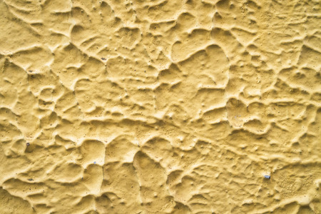 Old yellow texture stone wall abstract background. Copy space of graphic art design.