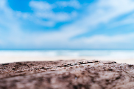 Blur tropical beach with bokeh sun light wave on empty old nature wood table abstract background....