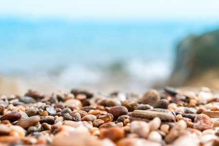 Close up rock sand with blur tropical beach and blue sky abstract background. Copy space of summer...