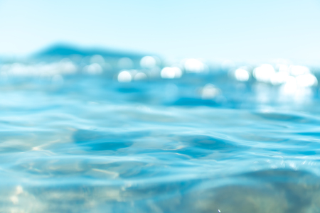 Abstract blur beach with bokeh sun light wave on sand texture background. Copy space of outdoor summer vacation and business travel adventure concept. Vintage tone filter effect color style.の写真素材