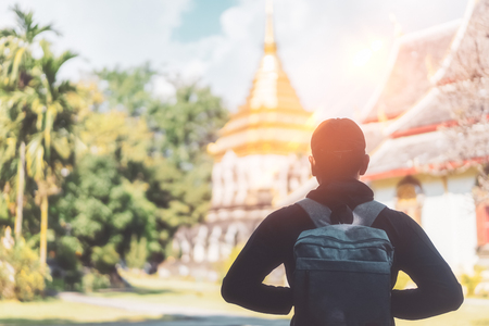 Backpacker man standing at temple background. Copy space of travel vacation and holiday adventure concept. Vintage tone filter effect color style.の写真素材