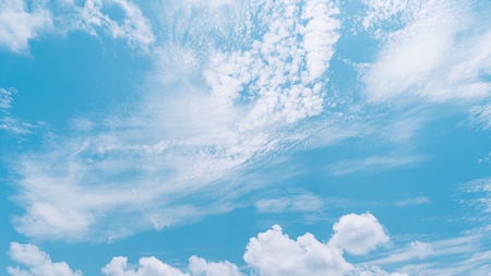 Blue sky and white clouds abstract background. Copy space nature and environment concept. Vintage tone filter effect color style.の写真素材