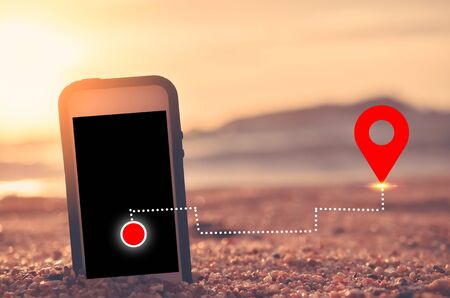 Smart phone on tropical sunset beach with gps navigator icon background. Technology business and...