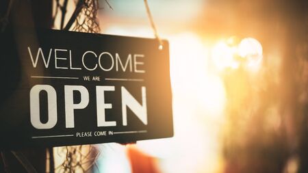 Open sign hanging front of cafe with colorful bokeh light abstract background. Business service and food concept. Vintage tone filter effect color style.の写真素材