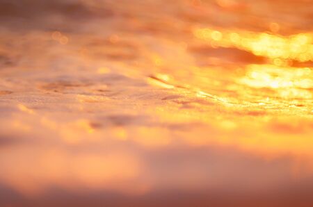 Tropical sunset beach with smooth wave and bokeh sunlight abstract background. Copy space of business summer vacation and travel adventure concept. Vintage tone filter effect color style.の写真素材