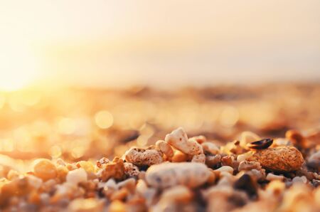 Tropical sunset beach with smooth wave and bokeh sunlight abstract background. Copy space of business summer vacation and travel adventure concept. Vintage tone filter effect color style.の写真素材