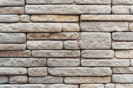 Old grunge brown stone brick wall texture abstract background. Copy space of horizontal architecture backdrop wallpaper.の写真素材