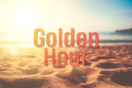 Golden hour words on blur tropical sand beach with bokeh sunlight wave abstract background. Copy space of business summer vacation and travel adventure concept. Vintage tone filter effect color style.の写真素材